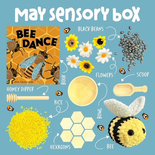 May sensory box with bee-themed items on a blue background